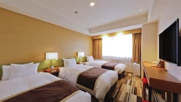 A hotel room with two beds, a desk, a TV, and a window with curtains.