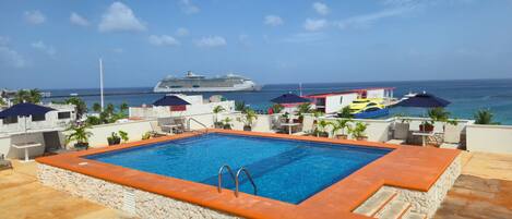 Outdoor pool, open 9:00 AM to 11:00 PM, pool umbrellas, pool loungers