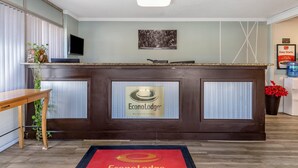 A reception desk with a logo, a television, and a framed artwork on the wall. - Econo Lodge Conway Central (Conway)