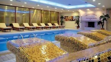 A pool area with lounge chairs and a reception desk.