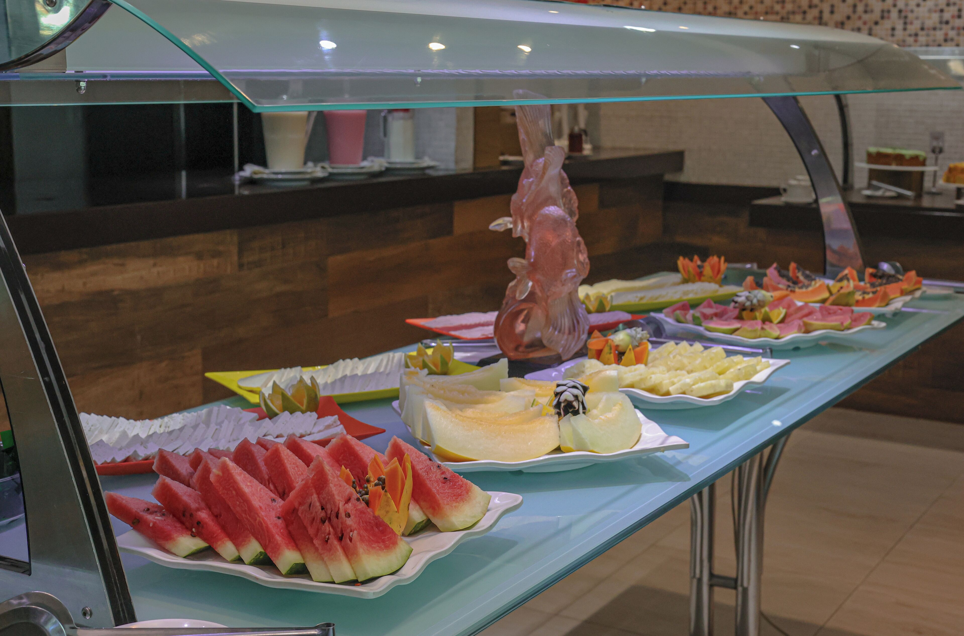A buffet with various fruits and desserts.