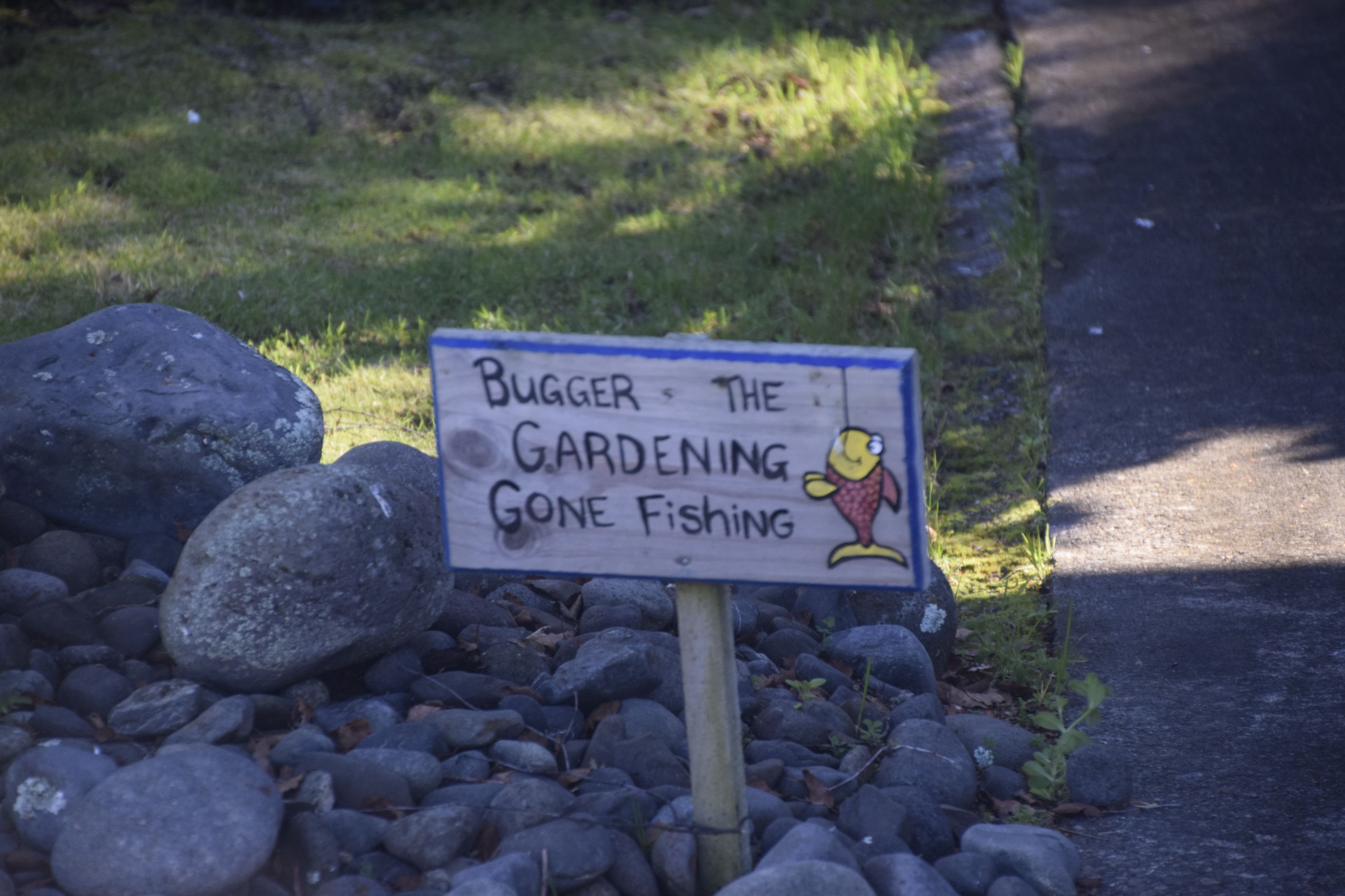 A sign with a cartoon character and text.