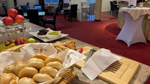 A buffet area with various food items including fruits, bread, and pastries. - Landhotel Zerlaut (Kisslegg)
