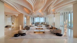 A spacious lobby with a unique ceiling design, large windows, and modern seating arrangements. - Hilton Pattaya (Pattaya)