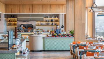 A modern restaurant with wooden accents, a central bar area, and seating arranged around it.