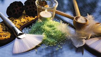 A table with a candle, a brush, and decorative items.