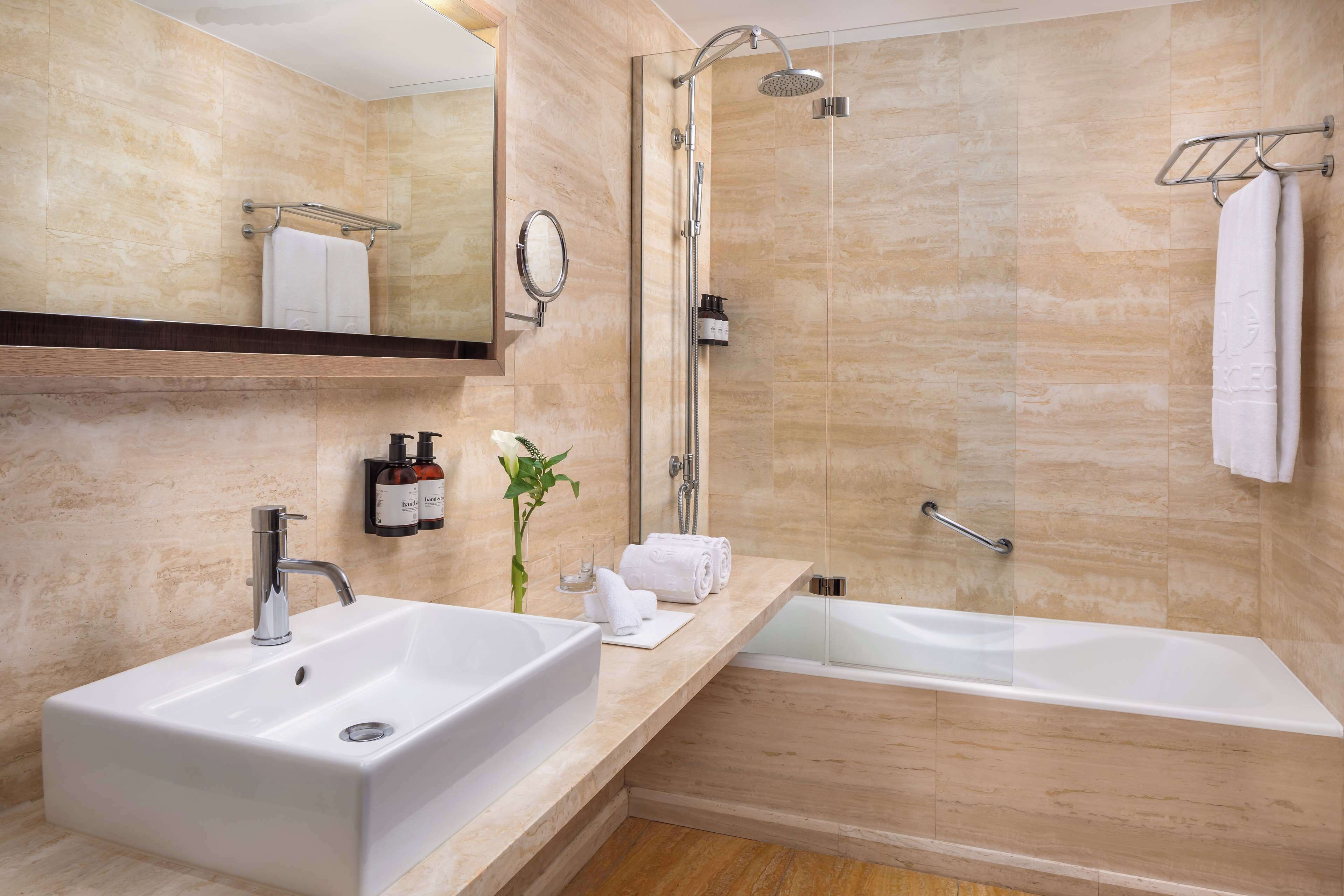 bathtub, eco-friendly toiletries, hair dryer, bathrobes