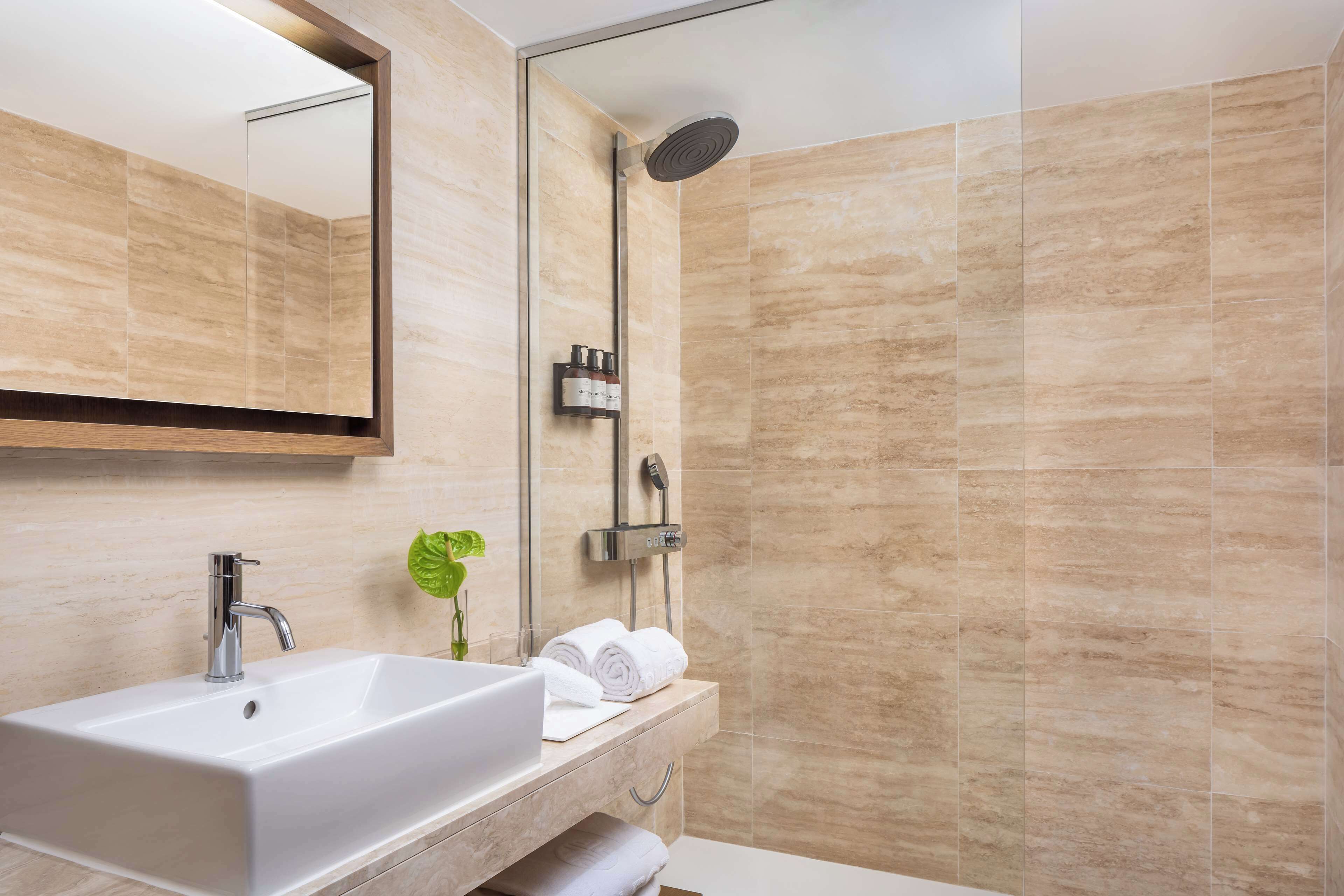 bathtub, eco-friendly toiletries, hair dryer, bathrobes