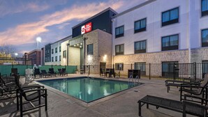 A hotel pool area with lounge chairs and a sign indicating 'Best Western Plus' accommodation. - Best Western Plus Austin Airport Inn & Suites (Austin)