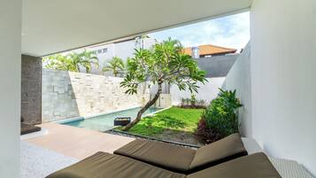 Un espacio exterior moderno con piscina y vegetación.