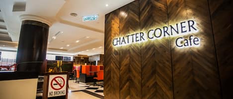A sign for 'Chatter Corner Cafe' with a 'No Smoking' sign in front.