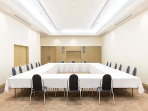 A conference room with a long table, chairs, and a wooden cabinet. - Grand Mercure Sapporo Odori Park (Sapporo)
