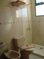 Baño con ducha, inodoro, bidé y lavabo.