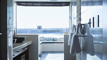 Ein modernes Badezimmer mit einem großen Fenster, einer Badewanne und einem Waschbecken.