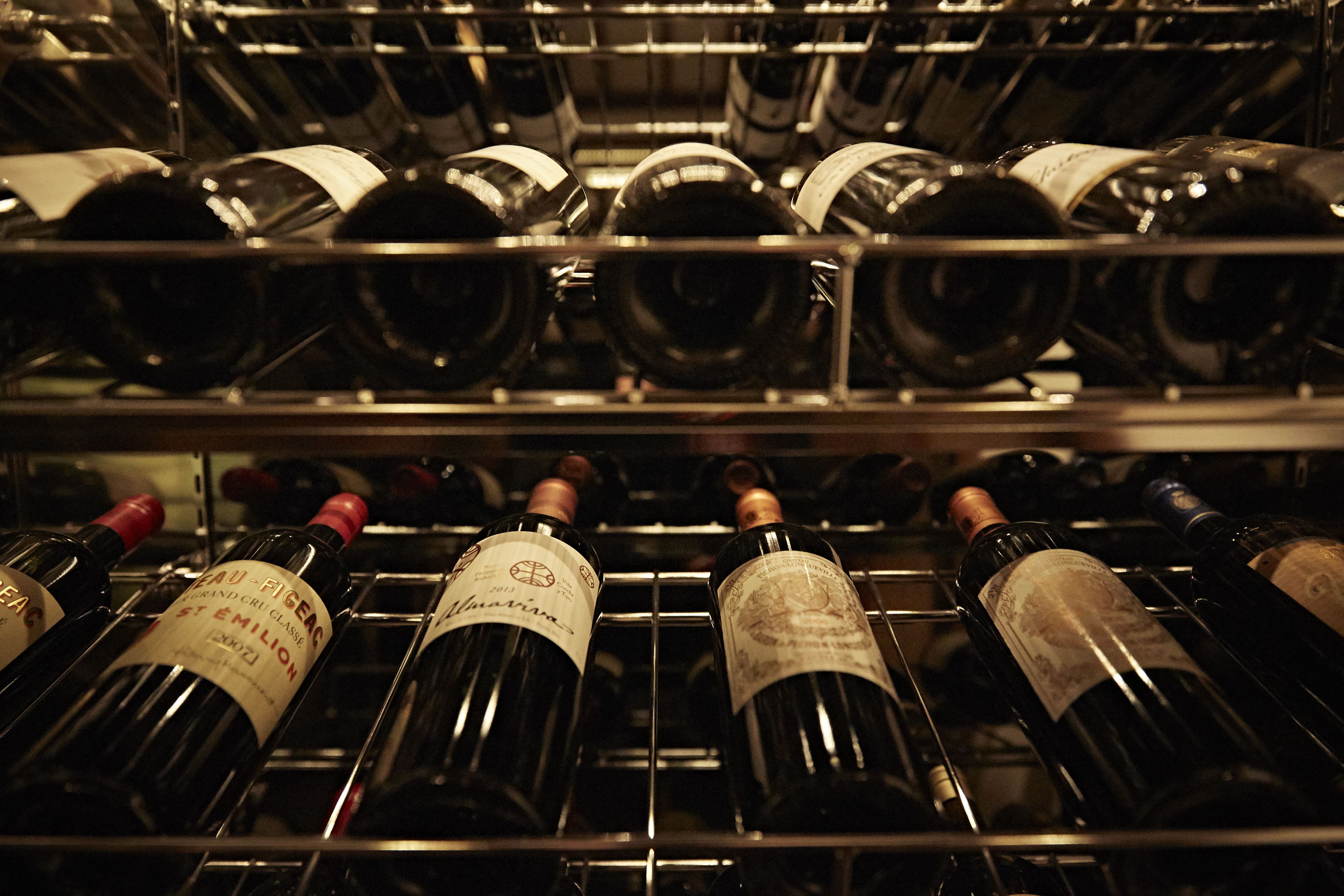 A wine rack with multiple bottles of wine.