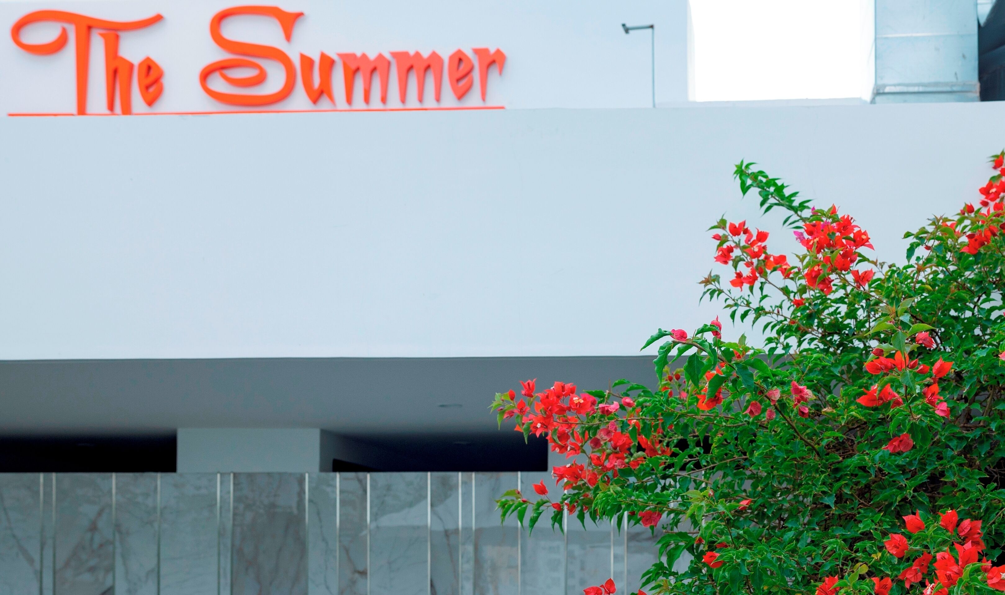 A building with a sign reading "The Summer" in red letters.
