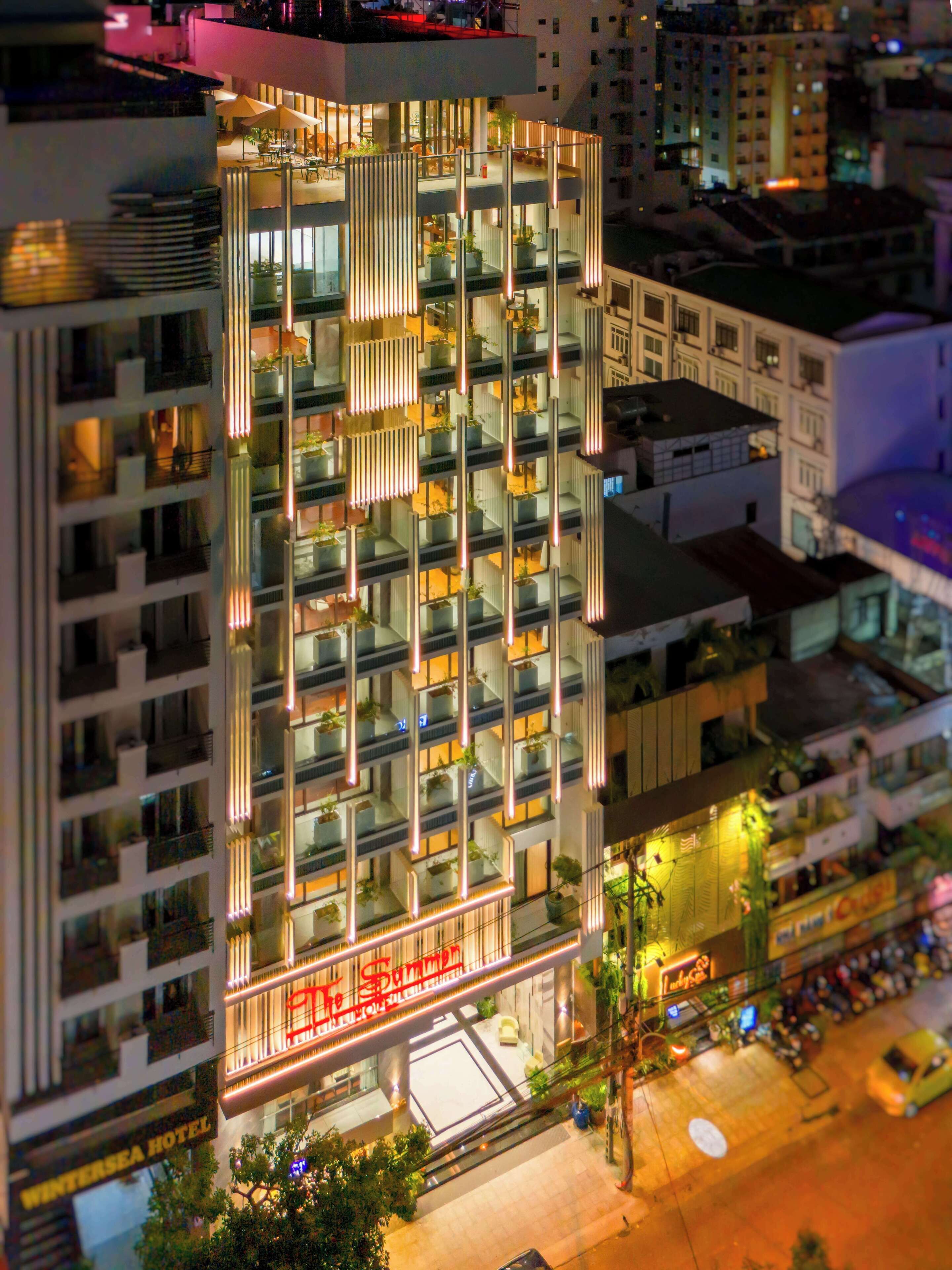 A multi-story hotel with balconies, a visible entrance, and a sign indicating it is a hotel.