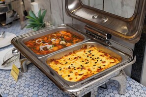 A buffet with two dishes: one appears to be a vegetable stew and the other a baked casserole with cheese. - The Summer Hotel (Nha Trang)