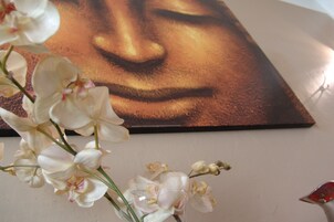 A painting of a woman's face on a wall.