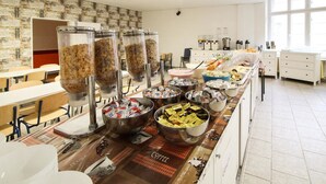 A buffet setup with various food items and beverages.