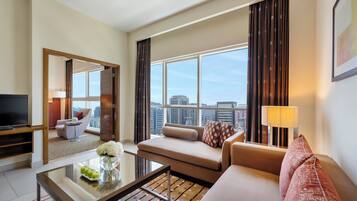 Executive One Bedroom Apartment | Living area | Smart TV, fireplace, video game console, DVD player