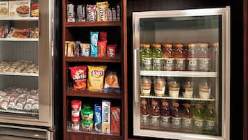 A refrigerated display case with various food items and beverages.