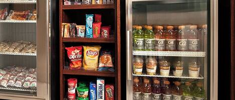 A refrigerated display case with various food items and beverages.