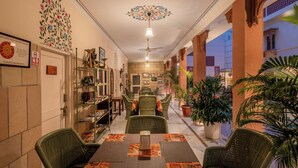 A hotel lobby with a reception desk, seating area, and a decorative ceiling. - Suryaa Villa - A City Centre Hotel (Jaipur)