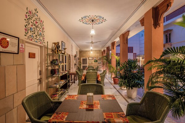 A hotel lobby with a reception desk, seating area, and a decorative ceiling. - Suryaa Villa - A City Centre Hotel (Jaipur)