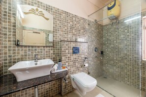 A bathroom with a sink, toilet, and shower. - Suryaa Villa - A City Centre Hotel (Jaipur)