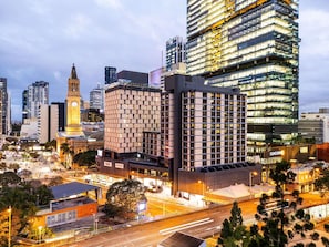 A modern urban skyline with high-rise buildings, a prominent clock tower, and a well-lit street. - Pullman Brisbane King George Square (Brisbane)