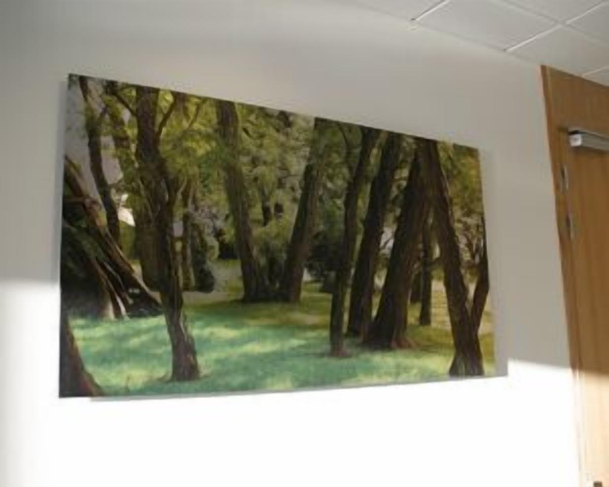 A painting of a forest scene on a wall.