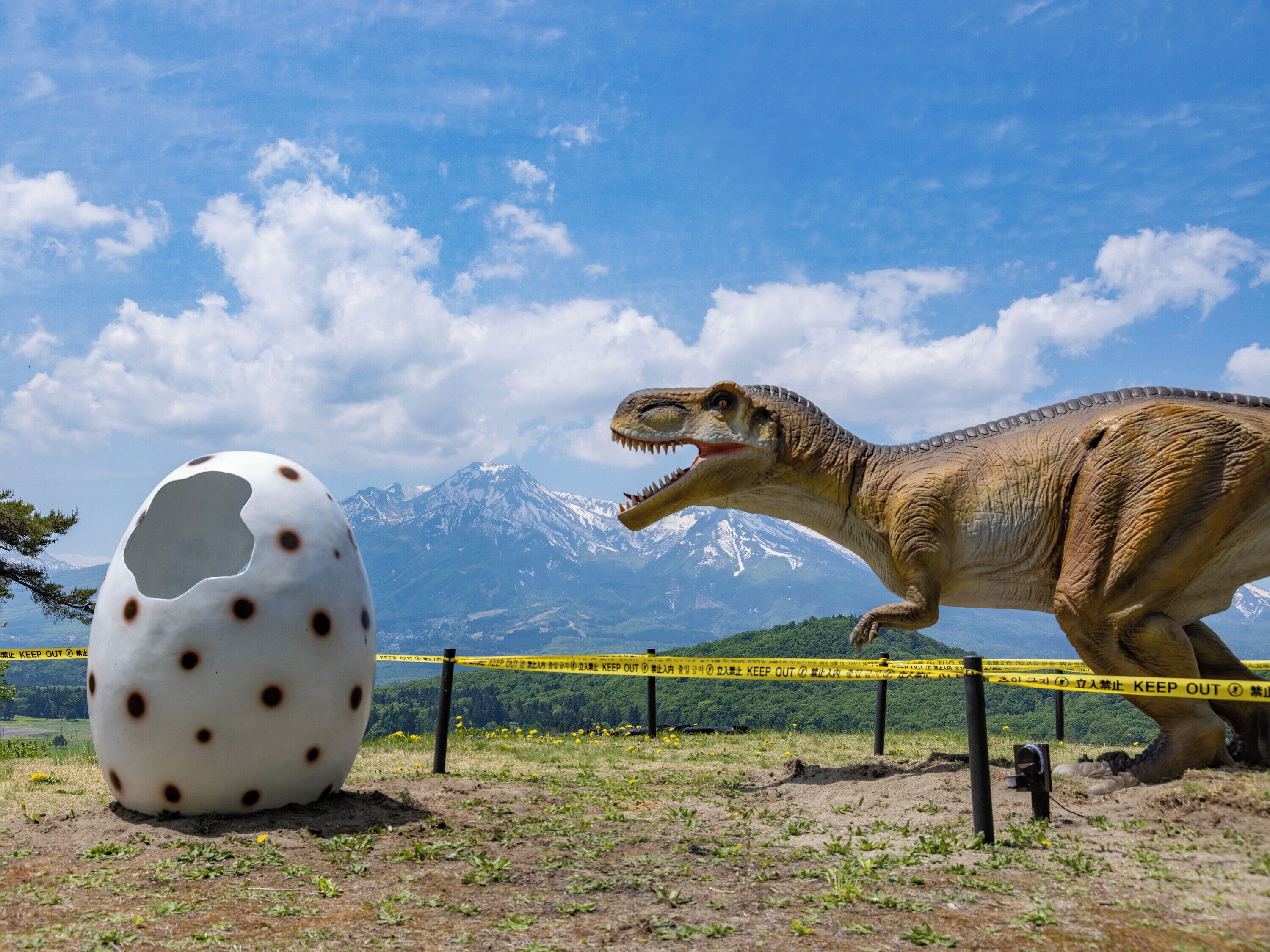 A dinosaur exhibit with a mountain in the background.