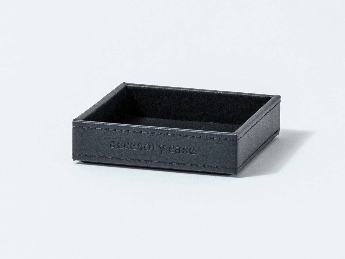 A black accessory case with a label.