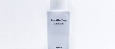 A white bottle of Face & Hand Soap with a pump dispenser.