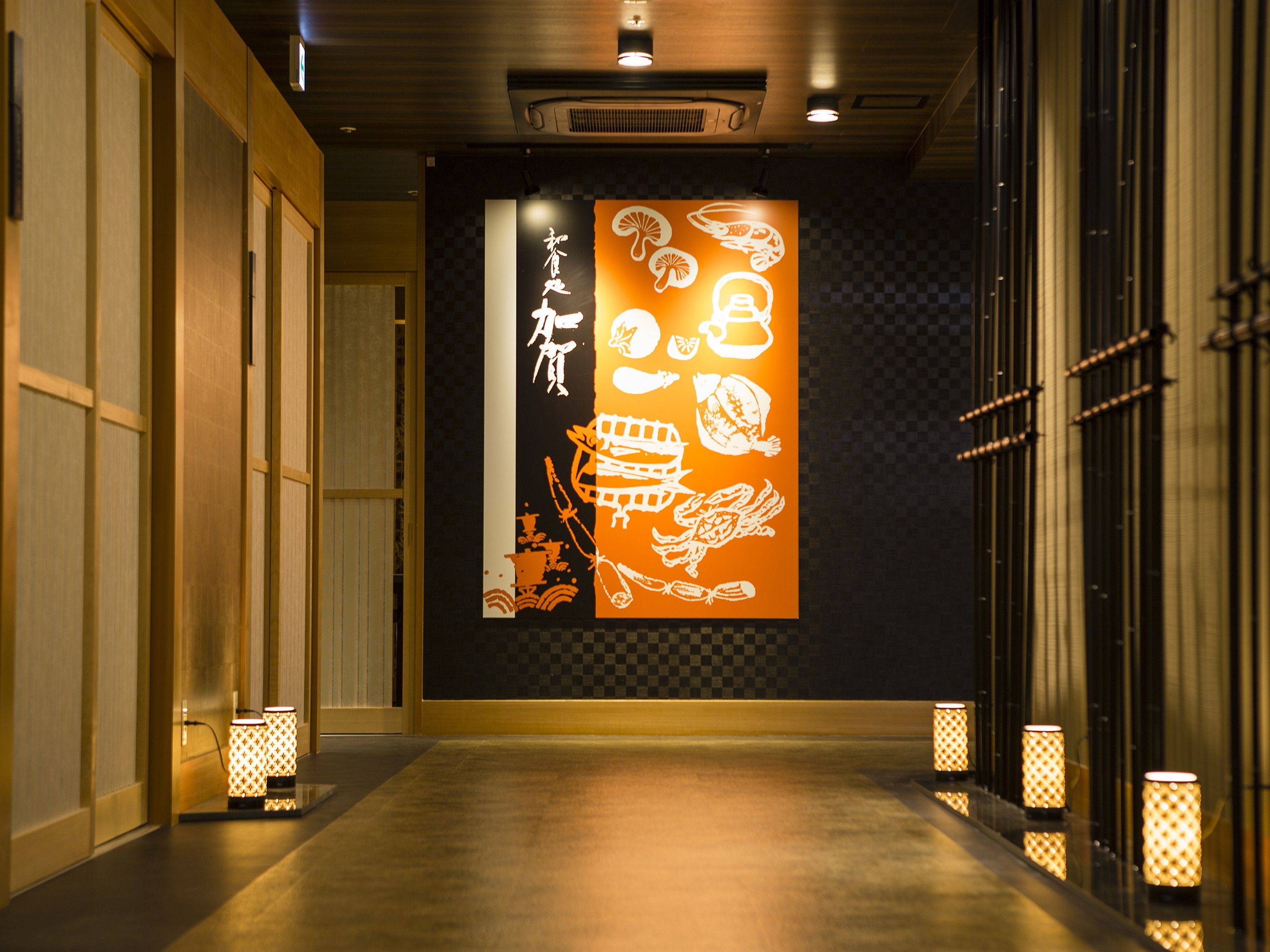 A hallway with traditional decor, including sliding doors and patterned lanterns.