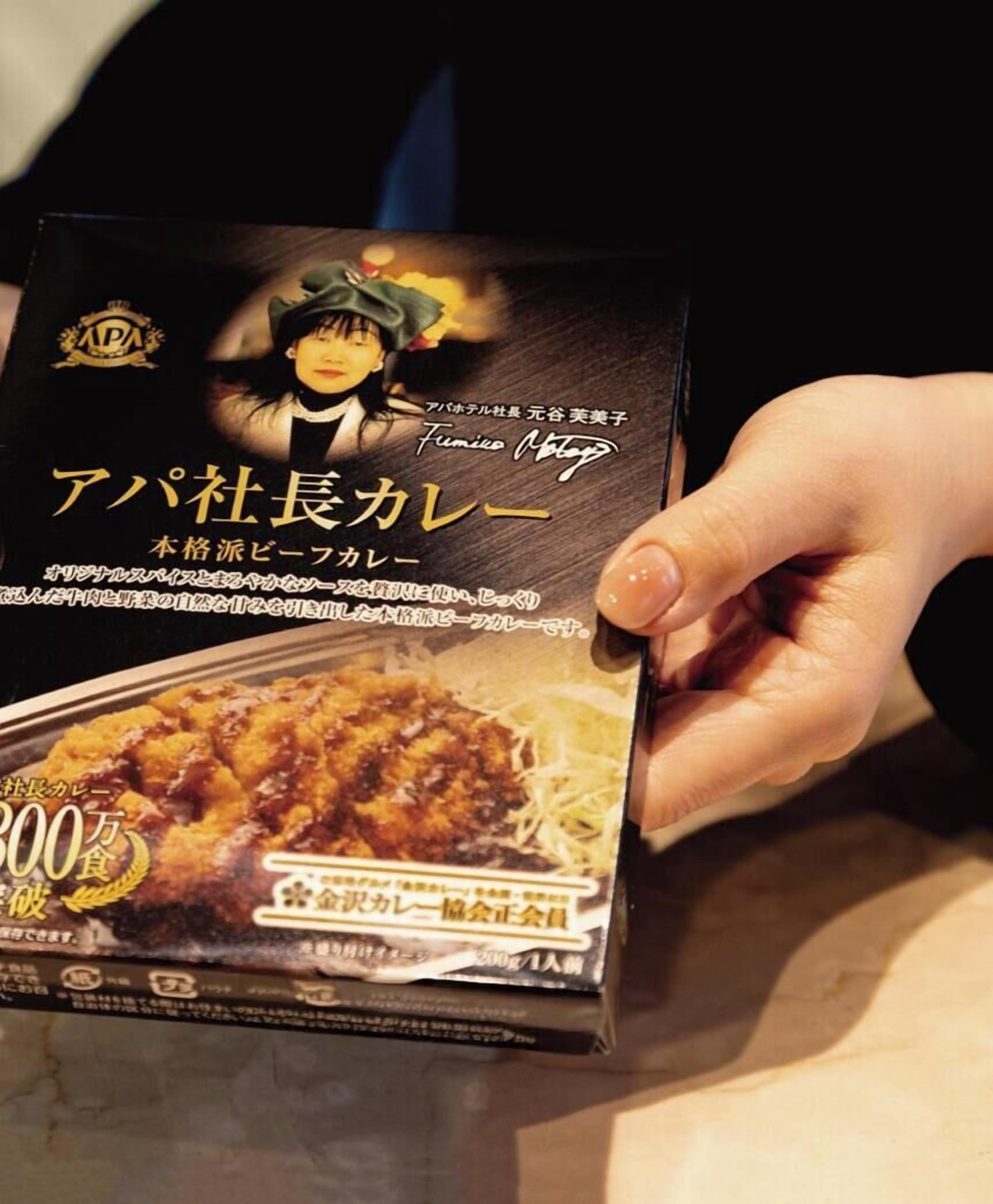 A person holding a box of food.
