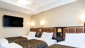 A hotel room with two beds, a flat-screen TV mounted on the wall, and two wall-mounted lamps.