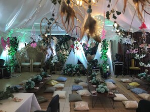 A tented event space with tables, chairs, and decorative elements like dream catchers and hanging lights. - NS Royal Hotel -city Center Cebu (Cebu City)