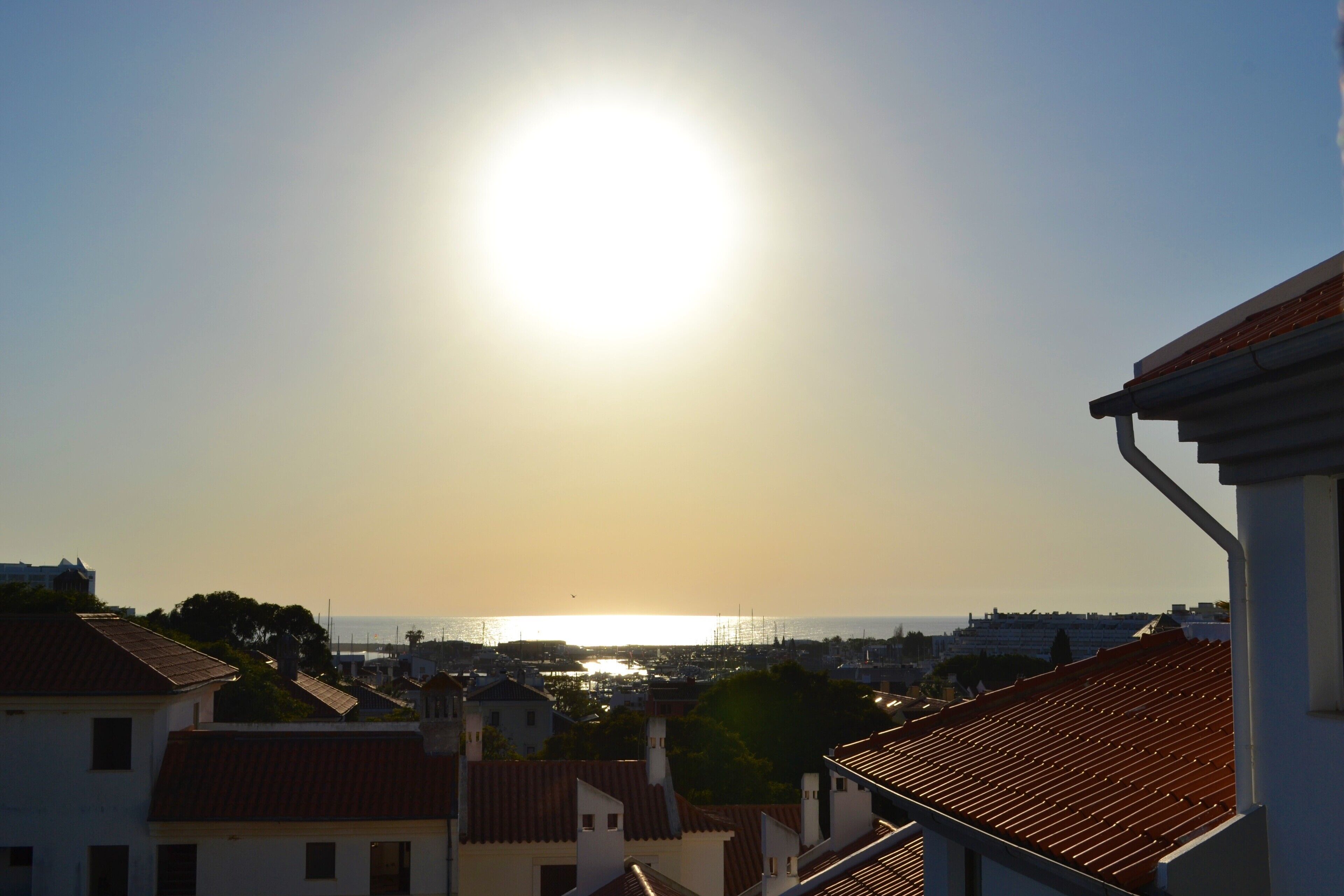 A coastal town with buildings and a clear view of the sea.