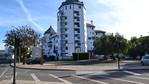 A multi-story building with balconies, a corner location, and a visible entrance. - Algardia Apartments (Loulé)