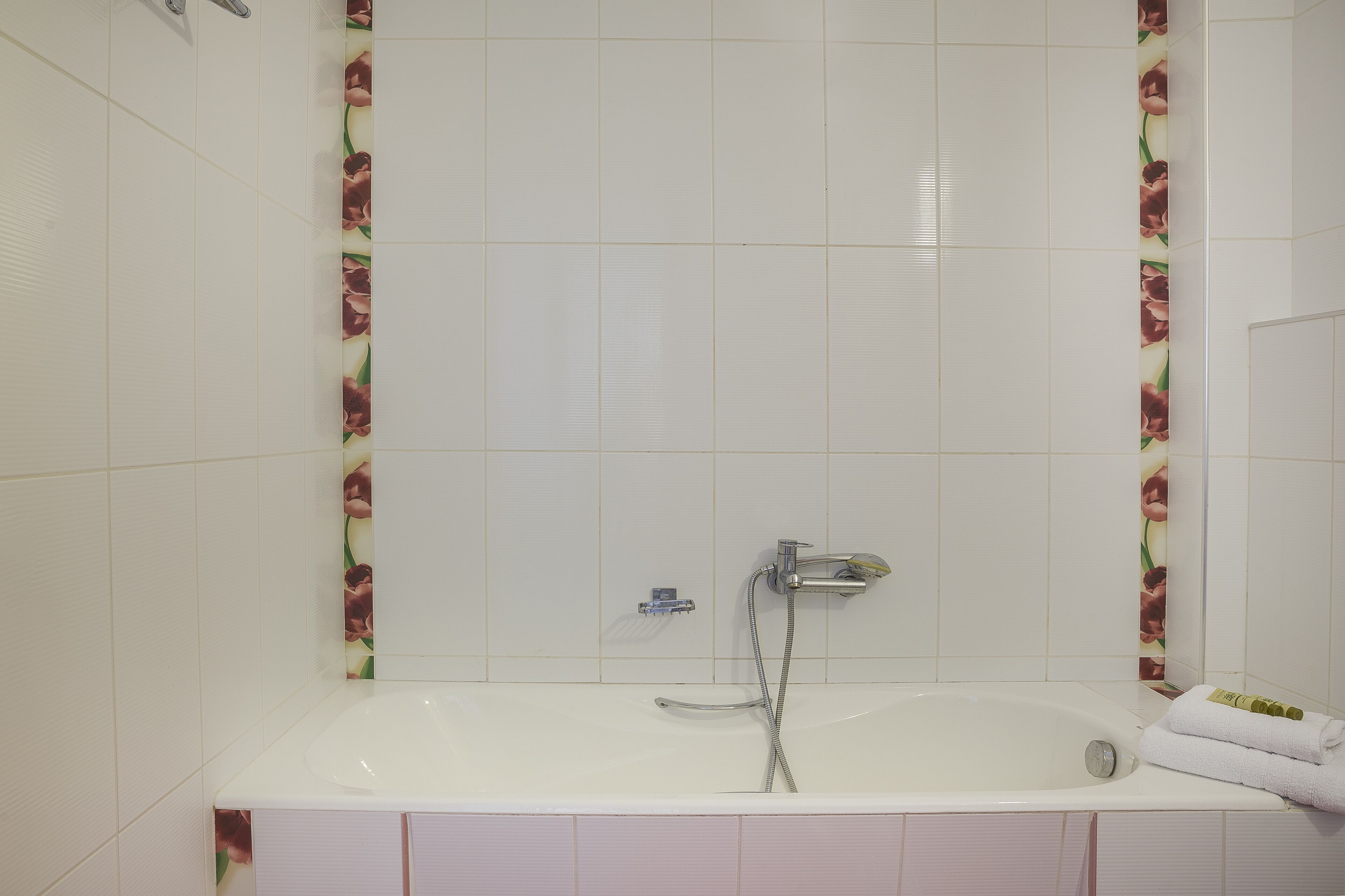 A bathroom with a bathtub, a shower, and a toilet.