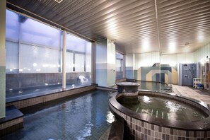 A spa area with a hot tub, a large window, and a tiled floor. - APA Hotel Fukui Katamachi (Fukui)