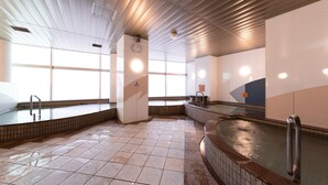 A spacious indoor swimming pool with clear water, tiled floors, and a modern ceiling design. - APA Hotel Fukui Katamachi (Fukui)