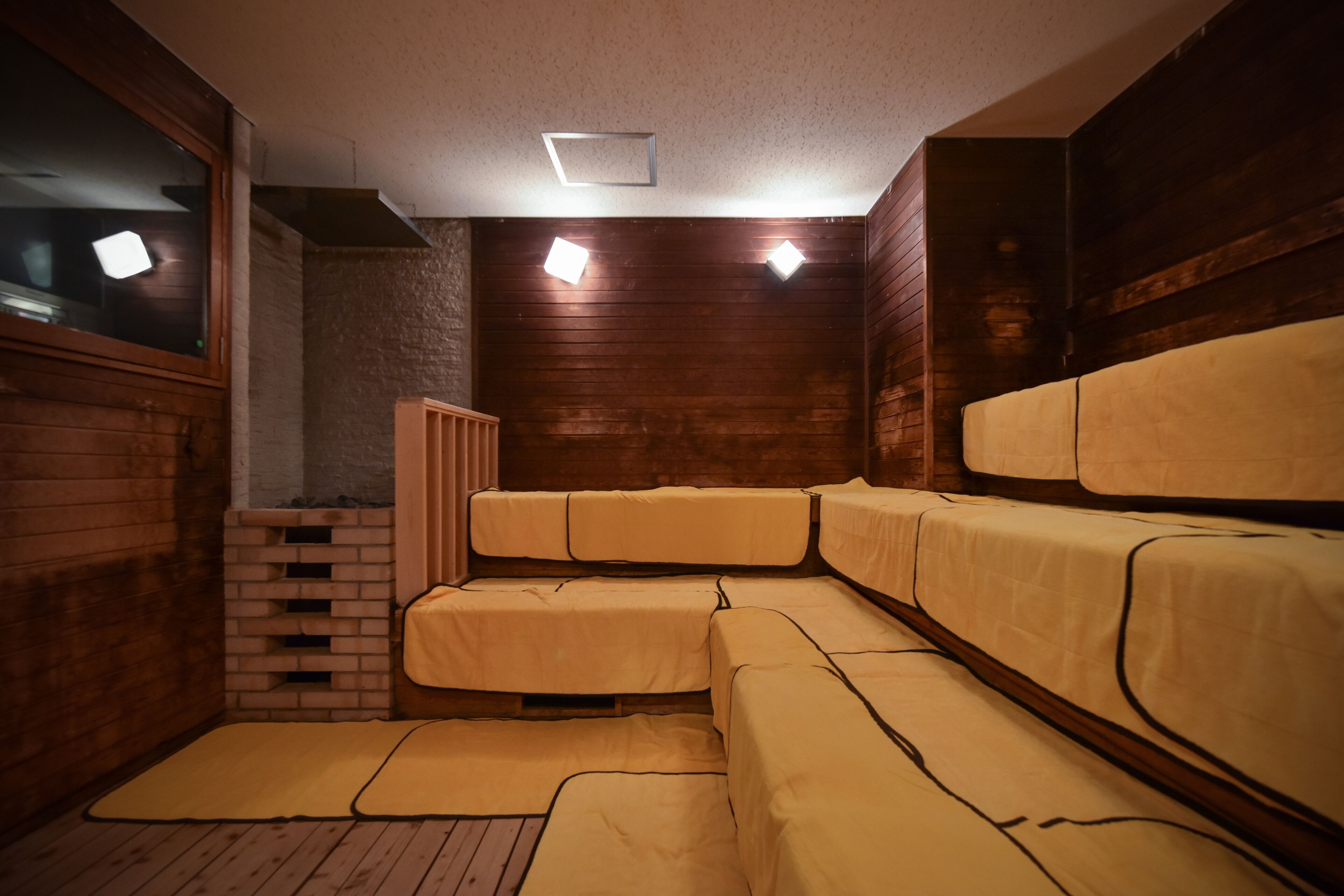 A room with wooden walls and a built-in bench seating area.