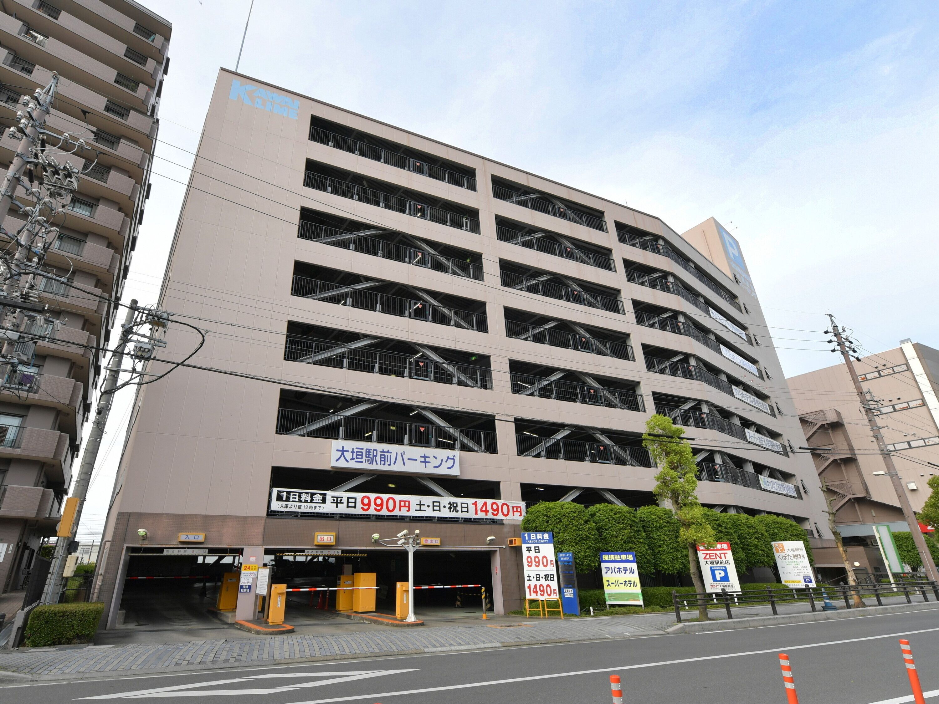 A multi-story parking garage with clear signage indicating entrance and exit points.