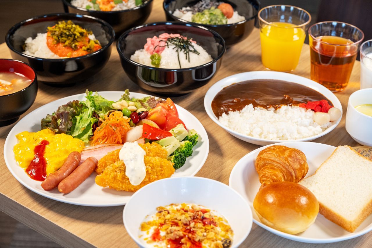 A variety of dishes including rice, vegetables, and bread, suggesting a meal setting.