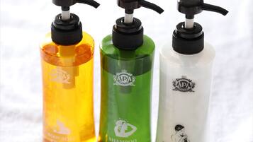 Three bottles of body soap, shampoo, and conditioner.
