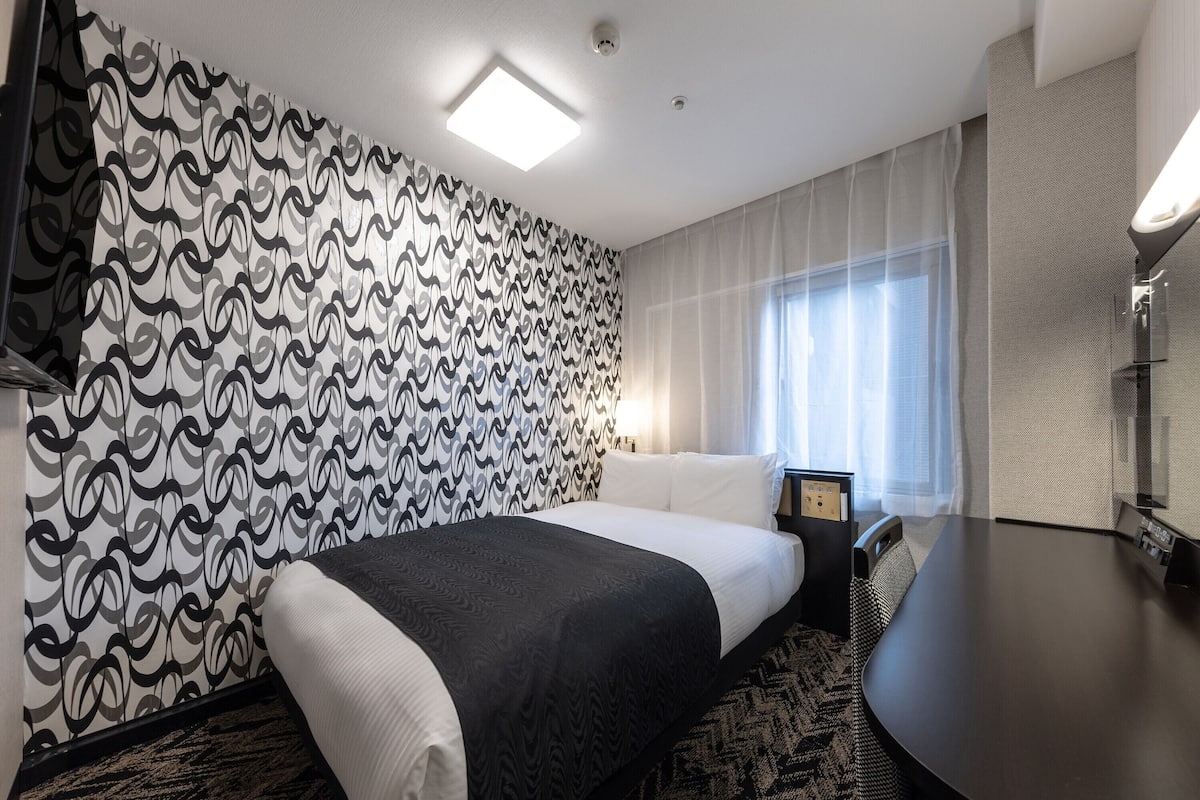 Luxe beddengoed, donzen dekbedden, een bureau, verduisterende gordijnen