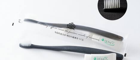 A toothbrush and a tube of toothpaste with Japanese text.